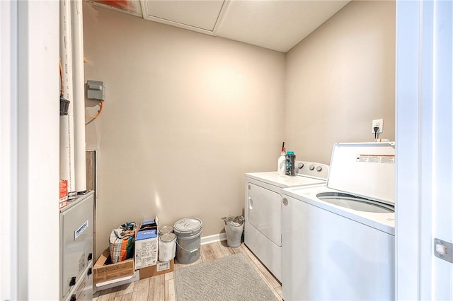 laundry area with washer and clothes dryer and light hardwood / wood-style floors