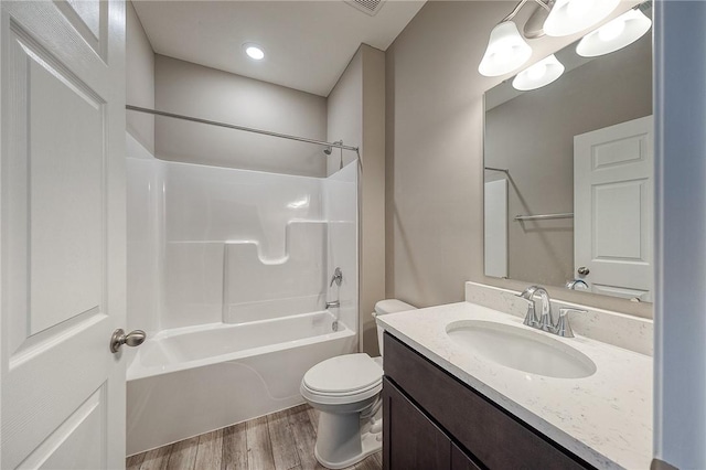 full bathroom with hardwood / wood-style flooring, shower / tub combination, vanity, and toilet