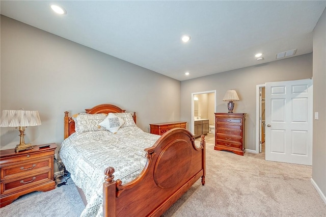 carpeted bedroom featuring ensuite bath