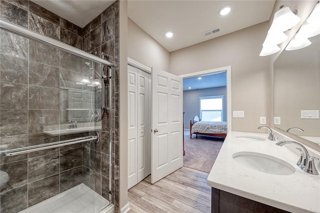 bathroom featuring vanity, wood-type flooring, and walk in shower