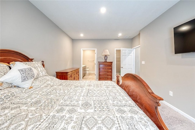 carpeted bedroom featuring ensuite bathroom