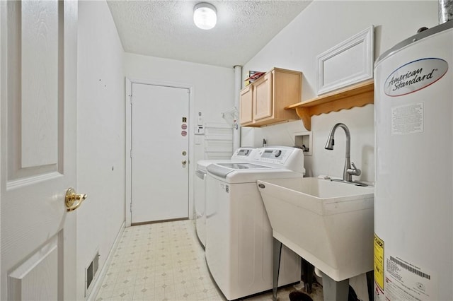 clothes washing area with sink, independent washer and dryer, cabinets, gas water heater, and a textured ceiling