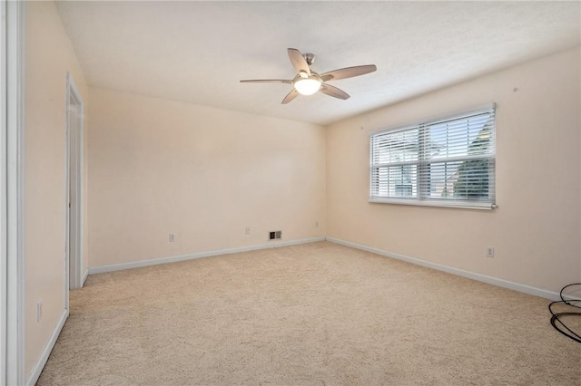 unfurnished room featuring light carpet and ceiling fan