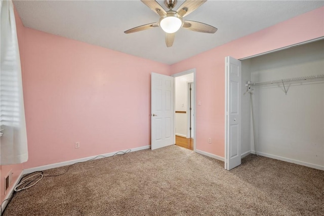 unfurnished bedroom with a closet, ceiling fan, and carpet flooring