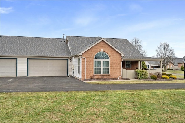 ranch-style house with a garage and a front lawn