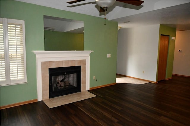 unfurnished living room featuring ceiling fan, hardwood / wood-style floors, and a fireplace