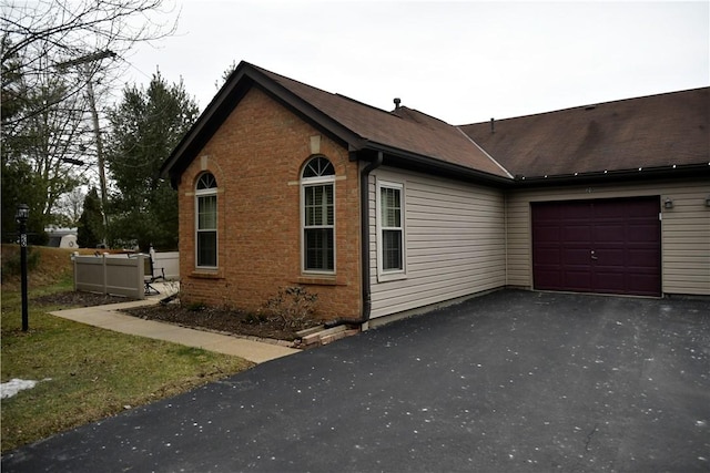 view of side of home featuring a garage