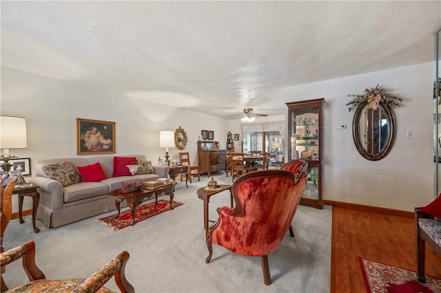 living room featuring ceiling fan and light hardwood / wood-style flooring