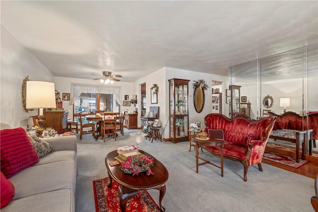 carpeted living room featuring ceiling fan