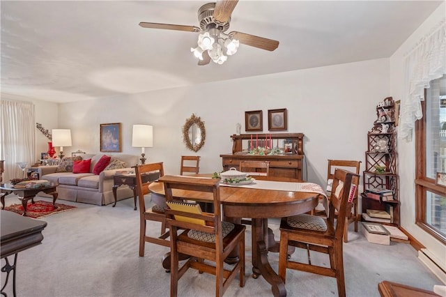 dining room featuring ceiling fan, a baseboard radiator, and light carpet