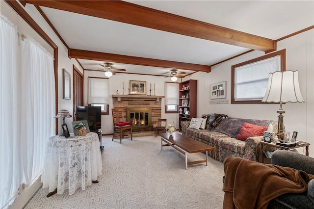 living room with ornamental molding, light colored carpet, and beamed ceiling