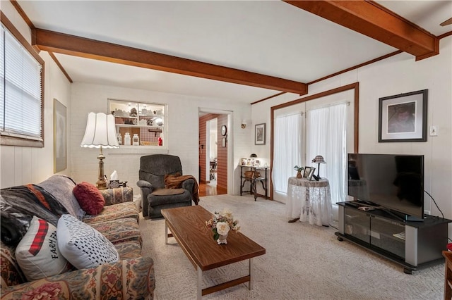 living room with light carpet and beamed ceiling