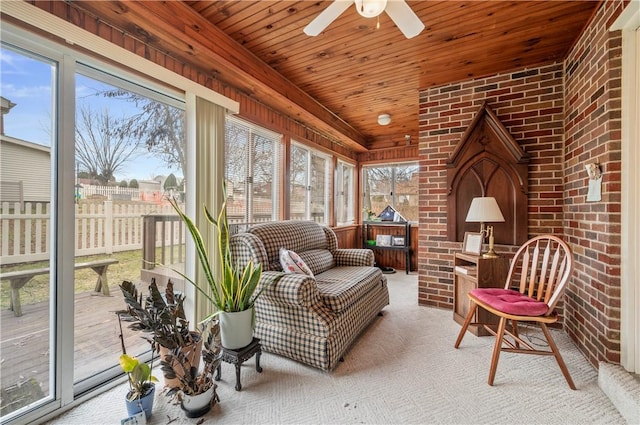 sunroom with wood ceiling and ceiling fan