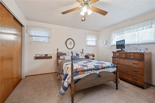 carpeted bedroom featuring multiple windows, a closet, and ceiling fan