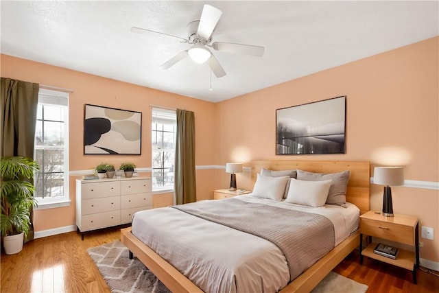 bedroom with wood-type flooring and ceiling fan