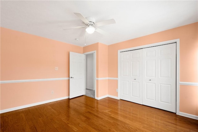 unfurnished bedroom featuring wood-type flooring, ceiling fan, and a closet