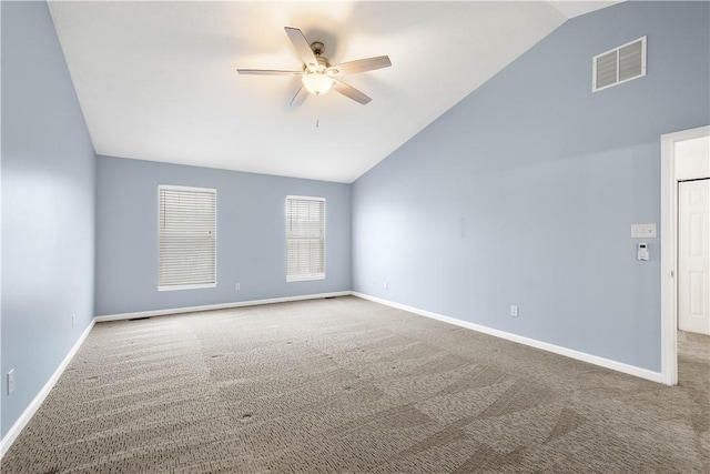 empty room featuring ceiling fan, carpet flooring, and vaulted ceiling