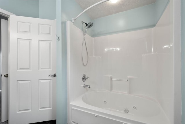 bathroom featuring bathing tub / shower combination and a textured ceiling