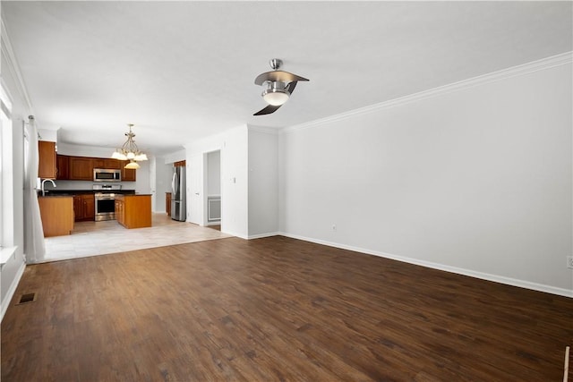 unfurnished living room with sink, crown molding, and light wood-type flooring