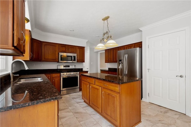 kitchen featuring a kitchen island, pendant lighting, sink, dark stone countertops, and stainless steel appliances