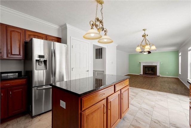 kitchen featuring crown molding, a notable chandelier, decorative light fixtures, and stainless steel fridge