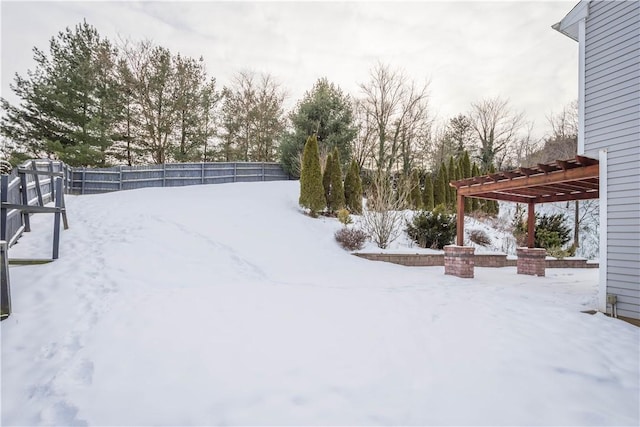 snowy yard with a pergola