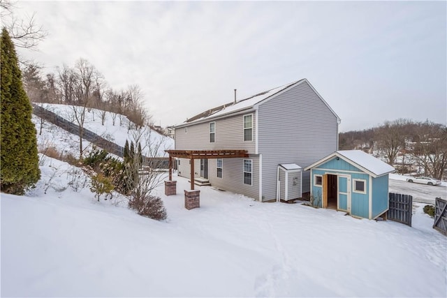 snow covered house with a shed