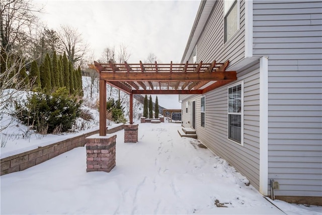 snow covered patio with a pergola