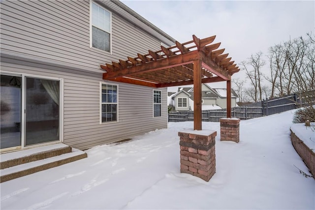 snow covered patio with a pergola