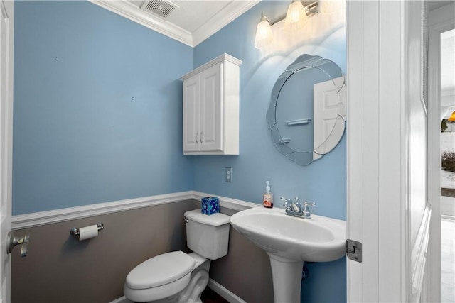 bathroom with crown molding and toilet