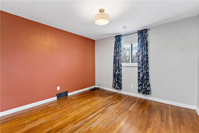 unfurnished room featuring hardwood / wood-style flooring