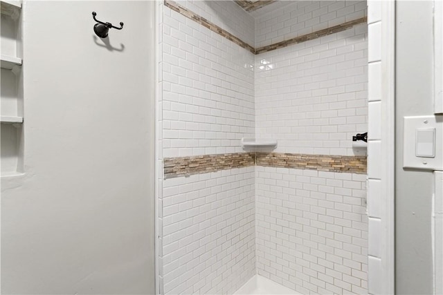 bathroom with a tile shower