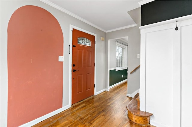 entryway featuring ornamental molding and dark hardwood / wood-style floors