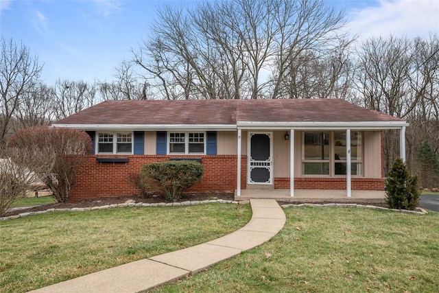 view of front of home with a porch and a front yard