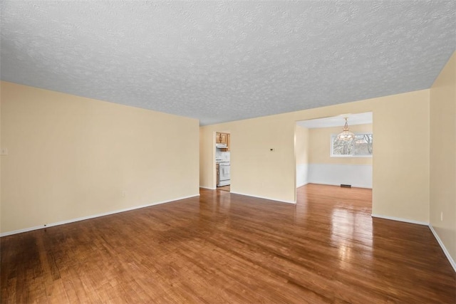 8422 Roosevelt Blvd, Mccandless, PA 15237 - unfurnished room featuring a chandelier, wood finished floors, and a textured ceiling