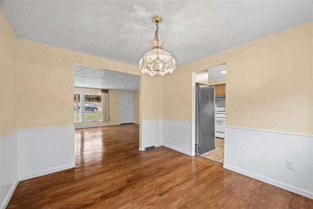 8422 Roosevelt Blvd, Mccandless, PA 15237 - spare room featuring a chandelier, wainscoting, and wood finished floors