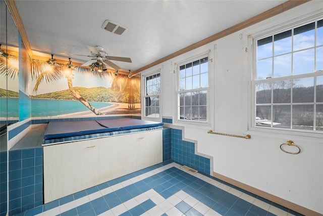 interior space with a hot tub, crown molding, tile patterned floors, and ceiling fan