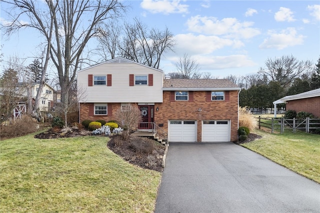 split level home with a garage and a front yard