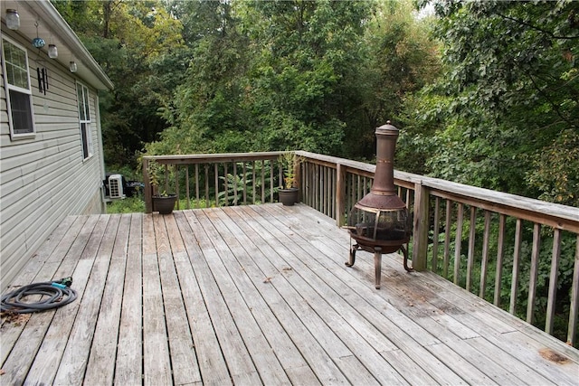 wooden terrace with a fire pit