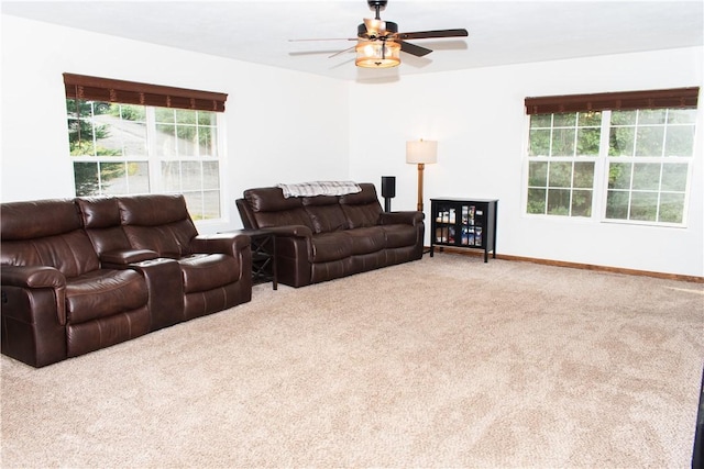 carpeted living room featuring ceiling fan