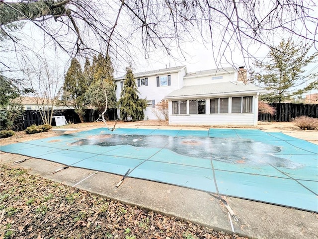 view of swimming pool with a diving board