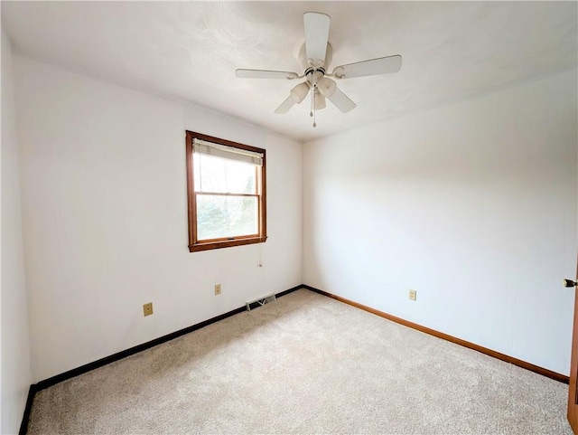 empty room with ceiling fan and carpet floors