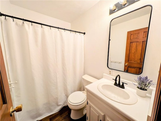 bathroom featuring vanity, hardwood / wood-style floors, and toilet