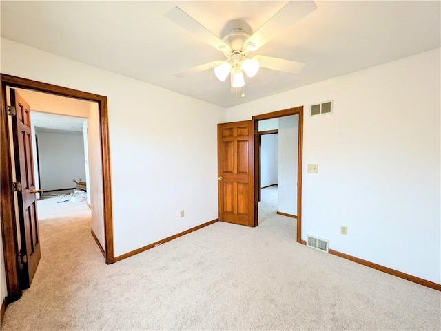 unfurnished bedroom with light carpet and ceiling fan