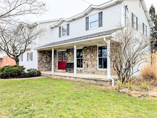 view of front of house with covered porch and a front lawn