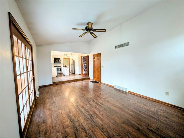 unfurnished living room featuring dark wood-type flooring, ceiling fan, and lofted ceiling