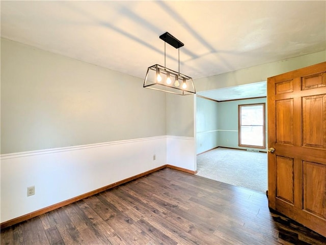 unfurnished dining area featuring dark hardwood / wood-style flooring