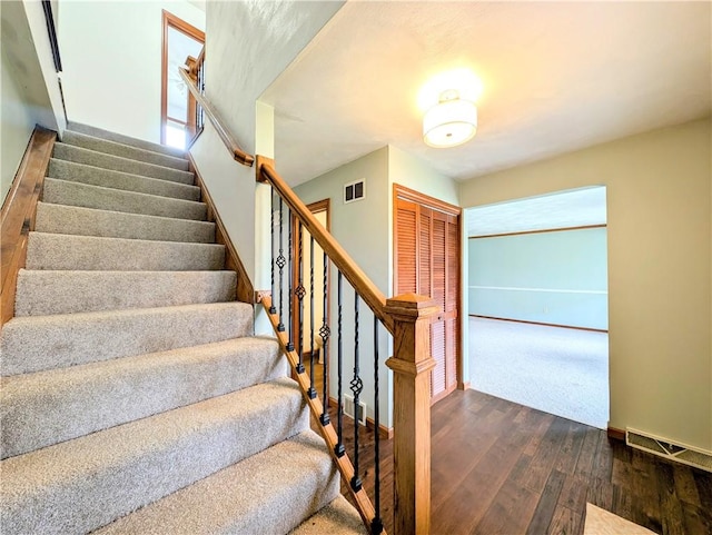 stairway featuring wood-type flooring