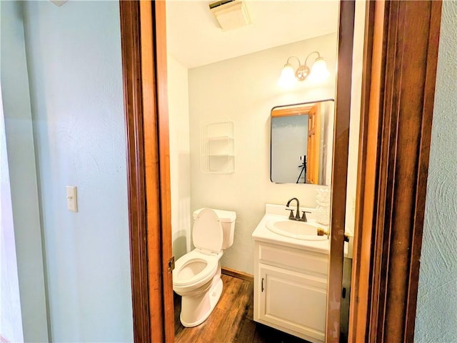 bathroom with vanity, wood-type flooring, and toilet