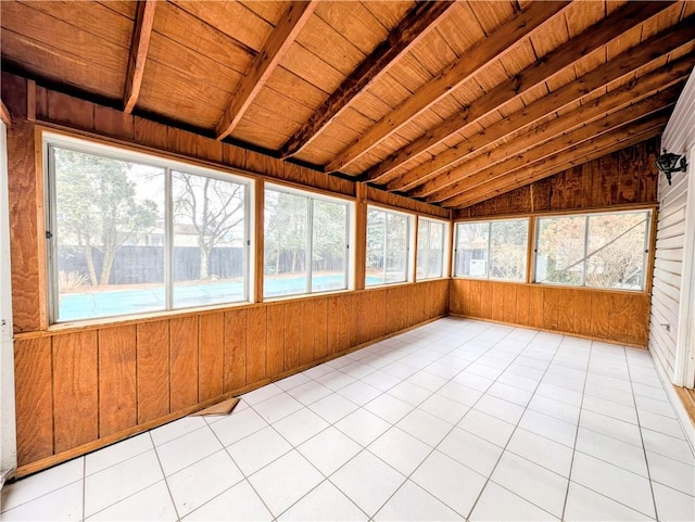 unfurnished sunroom with vaulted ceiling with beams, wood ceiling, and a wealth of natural light